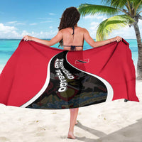 Red sarong with black diagonal crest graphic and white edging, worn as wrap