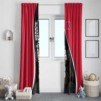 Pair of red window curtains with black-and-white diagonal crest graphic on center panels