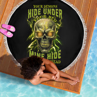 Round black beach blanket with neon green skull graphic and white fringe edge