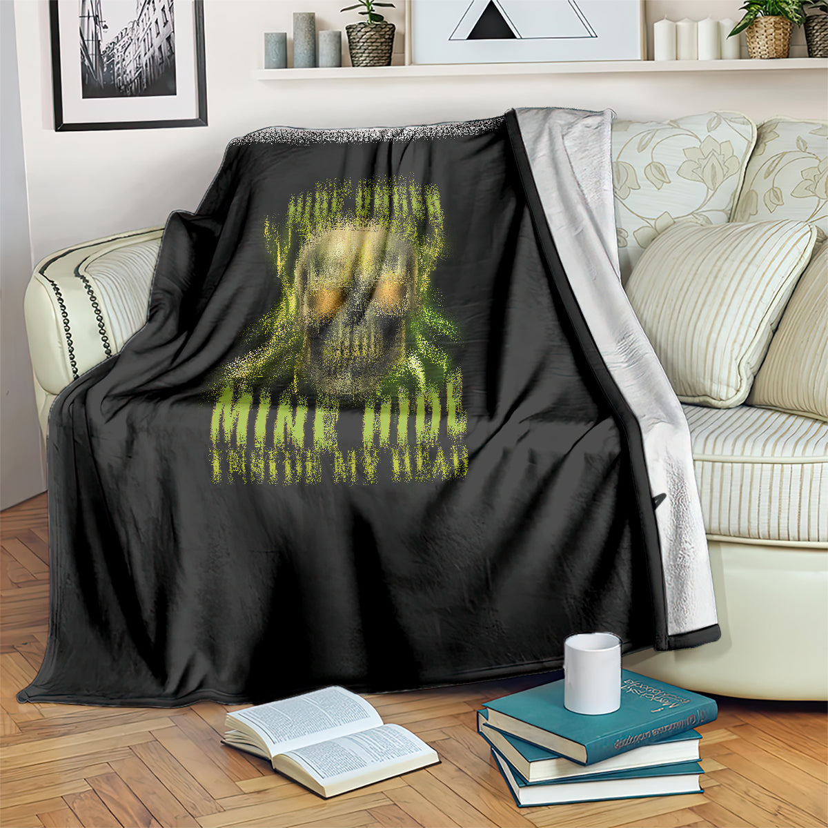 Black throw blanket over couch with neon skull graphic and yellow-green text
