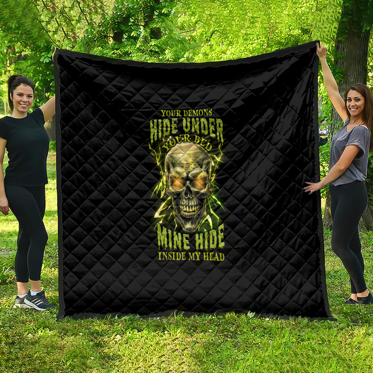 Black quilt with neon skull graphic and “hide under your bed” text, quilted diamonds