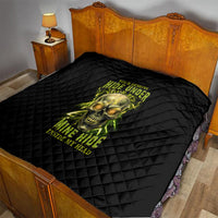 Black quilt spread on a bed with neon skull and glow text, diamond quilting