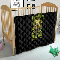 Black quilt on a wooden baby bed with neon skull graphic and glow text, diamond quilt