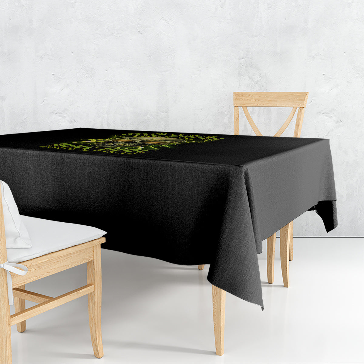 Black printed tablecloth with neon green skull graphic on tabletop edge