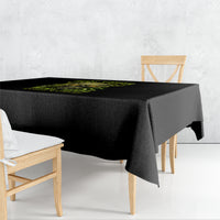 Black printed tablecloth with neon green skull graphic on tabletop edge