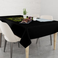 Black tablecloth with neon green skull lettering printed along the center