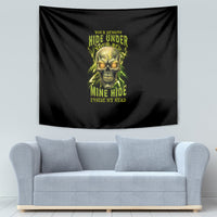 Black tapestry with neon green skull artwork centered