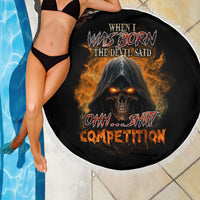 Black round beach blanket with fringed edge, devil skull graphic, draped on person
