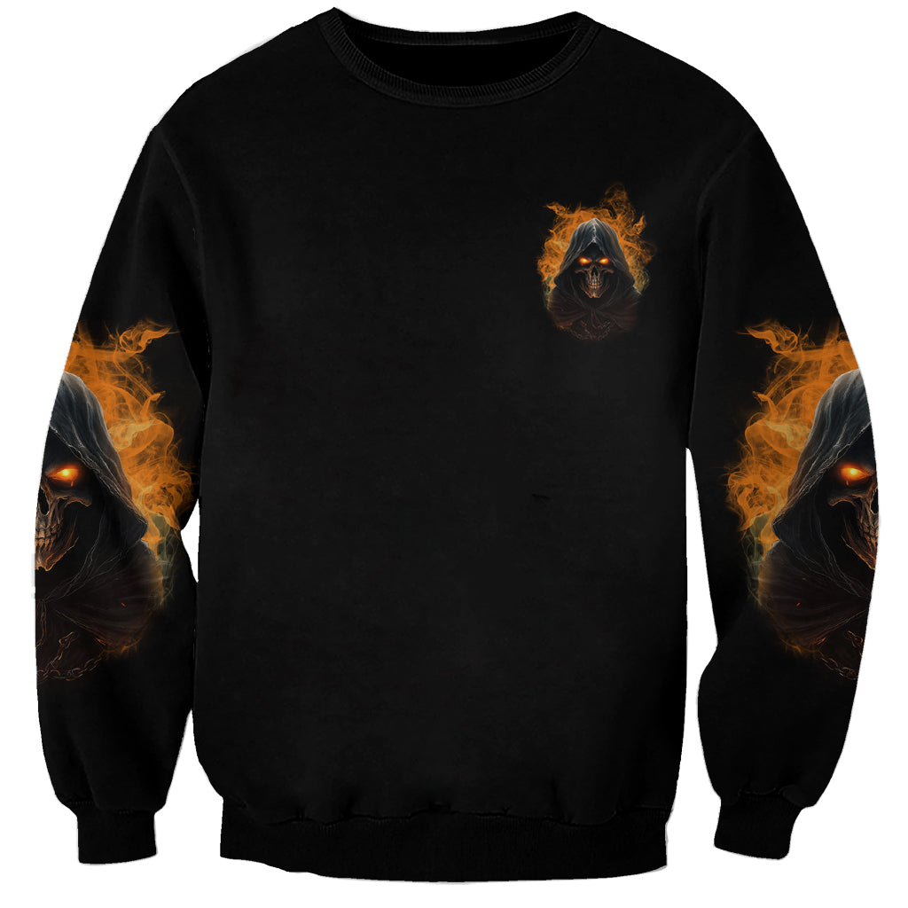 Black crewneck sweatshirt with small orange fire reaper skull emblem on chest