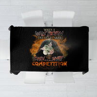 Black rectangular tablecloth with centered multicolor devil-theme print, stretched over table