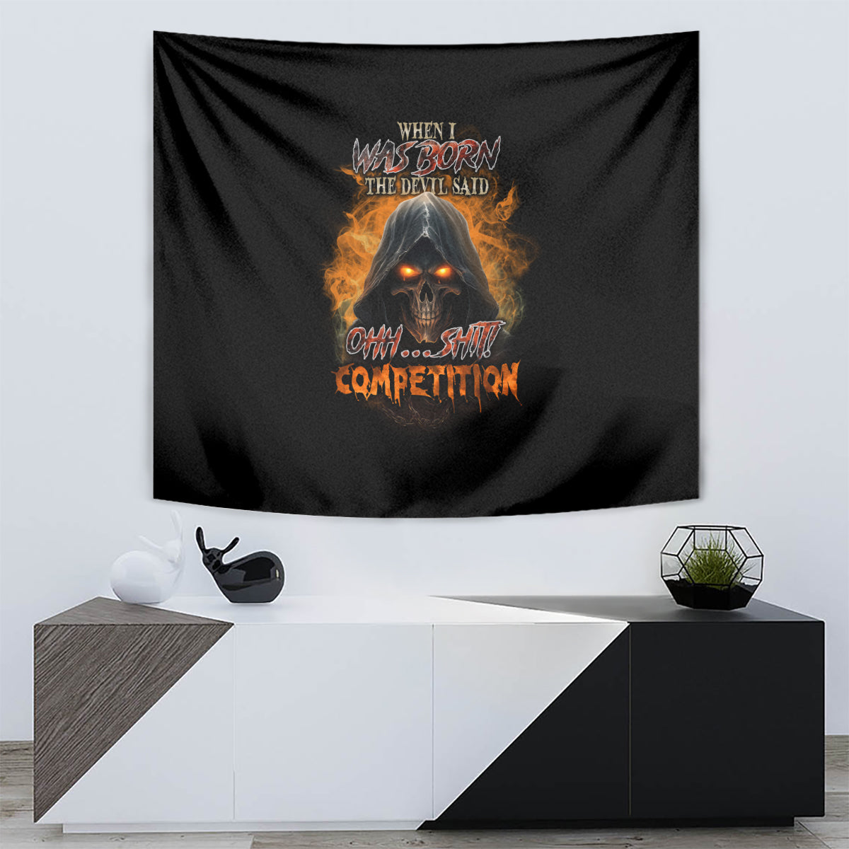 Black tapestry featuring a fiery skull face with glowing eyes and bold orange lettering