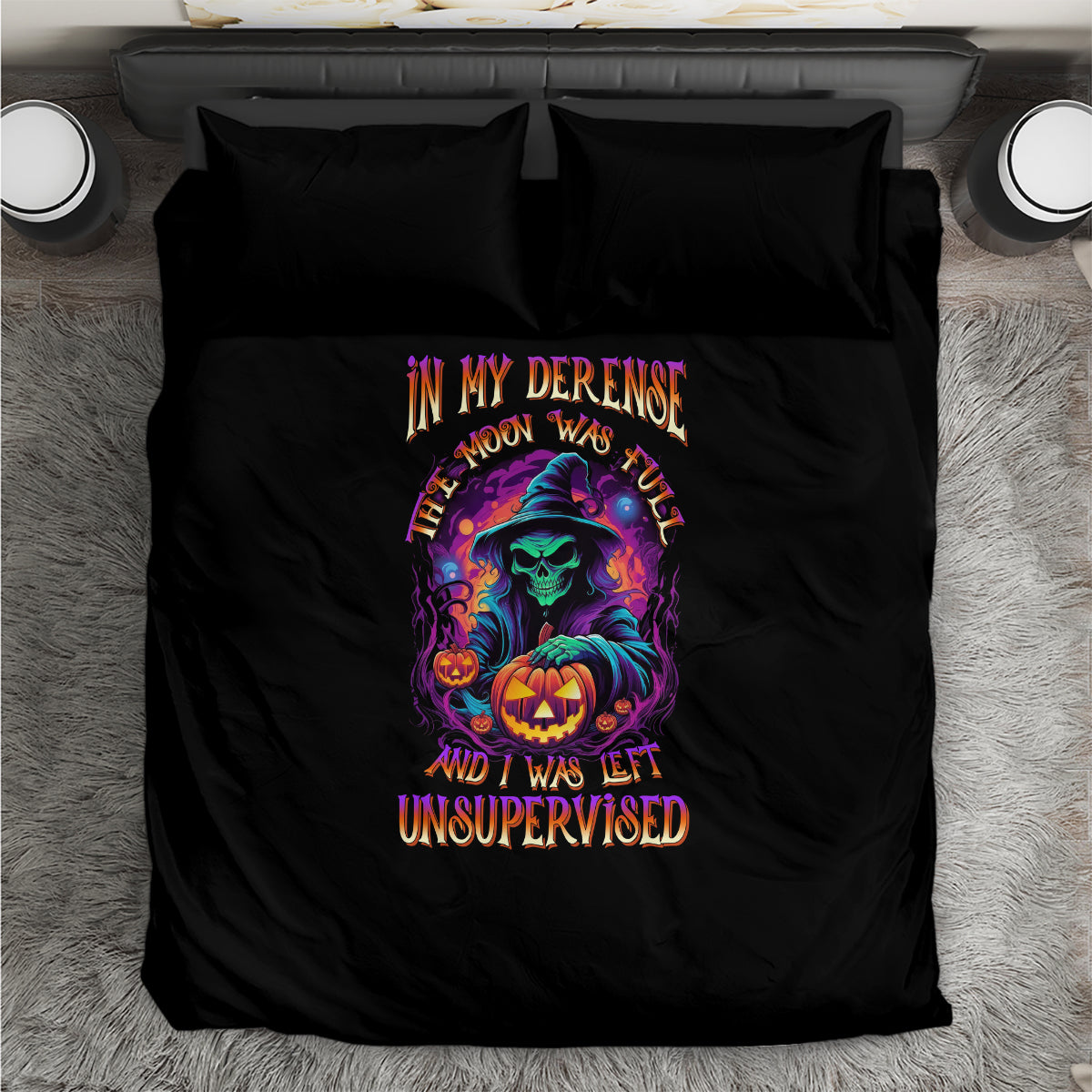 Black Halloween bedding set laid flat: witch, jack-o'-lantern, and multicolor slogan on duvet
