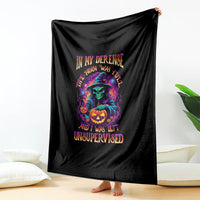 Black Halloween blanket draped with witch, jack-o'-lantern, and 'Unsupervised' wording
