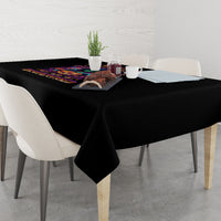 Black Halloween tablecloth with multicolor graphic print on top surface near the corner
