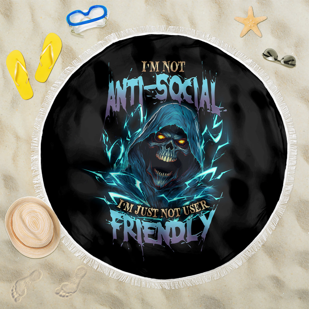 Round beach blanket with blue glowing skull face graphic, black base, white fringe