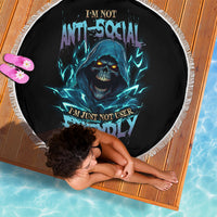 Round beach blanket, black with blue skull graphic and white fringed edge