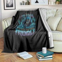 Black skull-themed blanket with blue glowing design, draped over couch