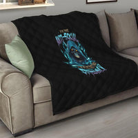 Black quilted sofa throw with blue skull graphic centered on the fabric