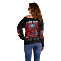 Women's off-shoulder black sweater with red and blue skull graphic, angled back view