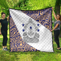 White and blue quilt featuring national emblem overlaid on traditional pattern border.