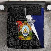 Black patterned bedding set with Honduras-style coat of arms and blue side panel