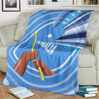 Blue Somalia flag blanket covering couch with raised fist graphic and white circular lines