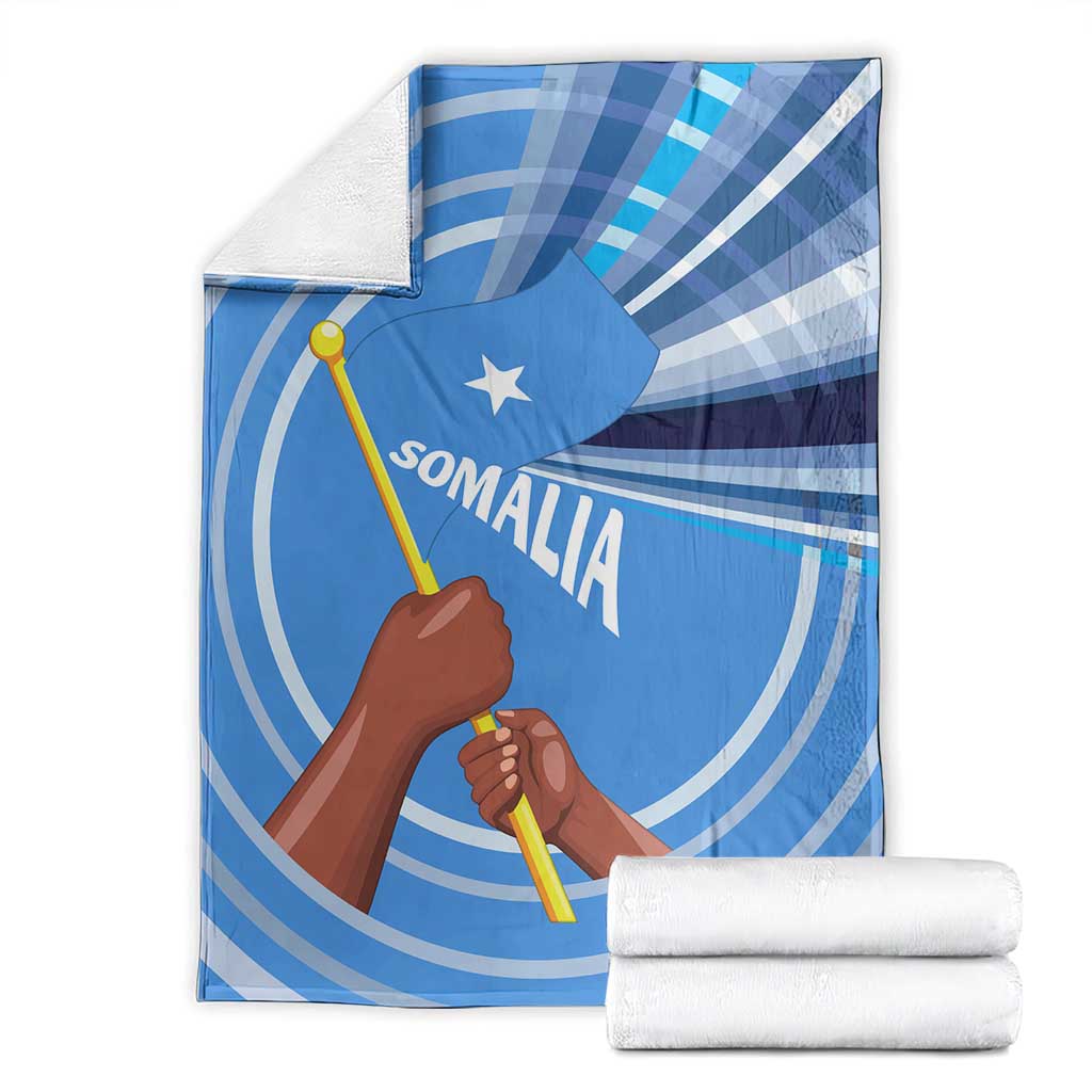 Blue Somalia flag blanket folded with raised fist, star, and Somali text graphic
