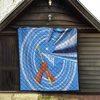 Blue and white Somalia flag quilt displayed in a doorway, raised fist and star design