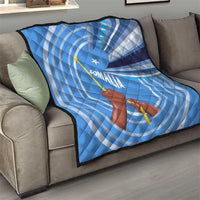 Blue and white Somalia flag quilt draped on a couch with raised fist and star