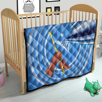Blue and white Somalia flag quilt on a baby bed, raised fist and spear with star