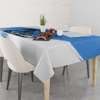 Blue and white tablecloth on dining table with patterned border and corner print