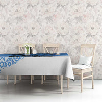 Blue and white tablecloth with geometric border on dining table