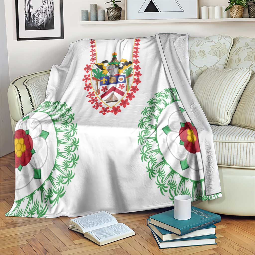 White blanket with Saint Kitts and Nevis crest, red floral border, green palm and hibiscus designs