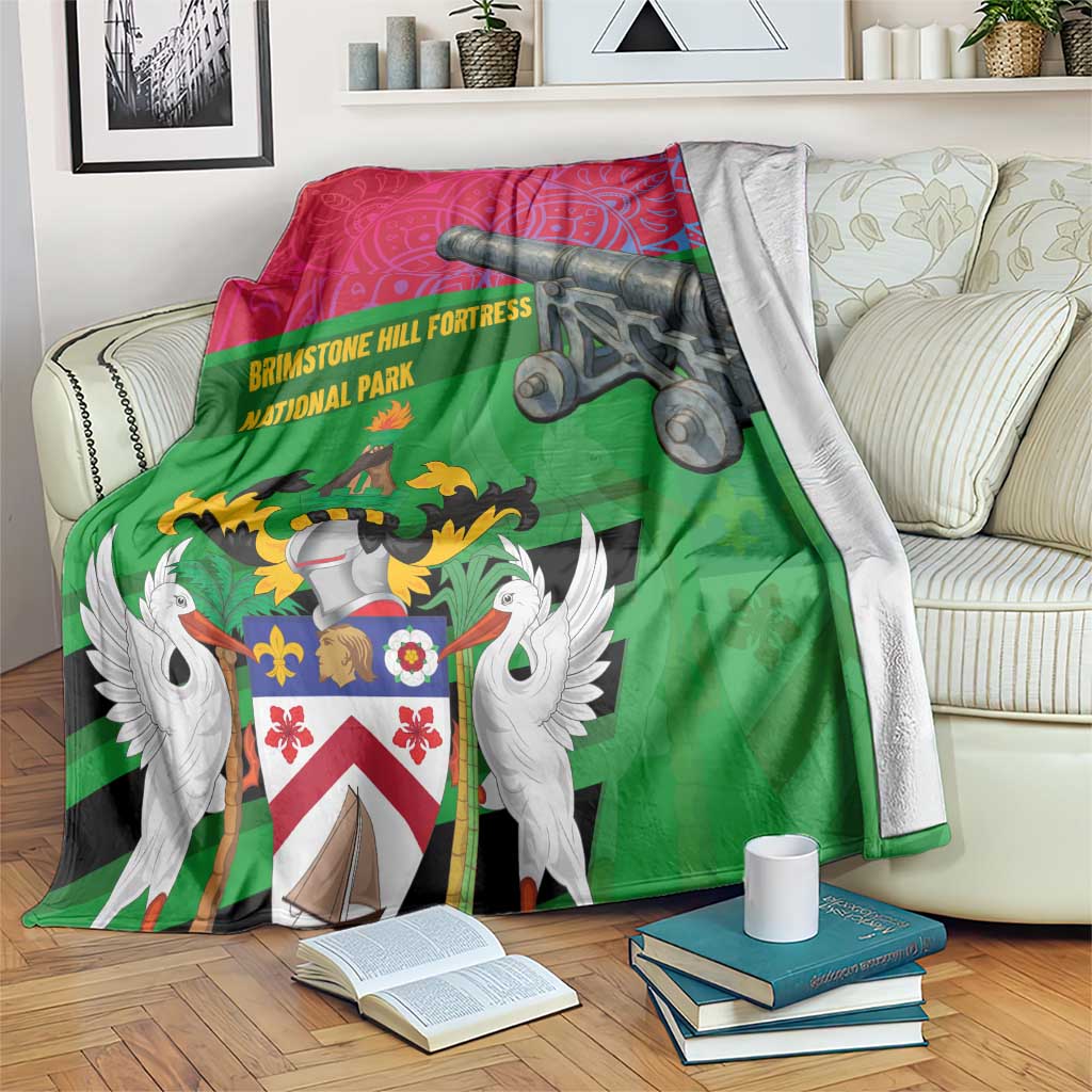 Red and green Saint Kitts and Nevis blanket with coat of arms and cannon graphic