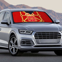 Red car sun shade with gold crest on front windshield
