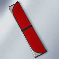 Red auto sun shade panel with black edge and silver backing