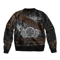 Bomber jacket with dark pattern, diagonal brown strap, and large silver Viking emblem print