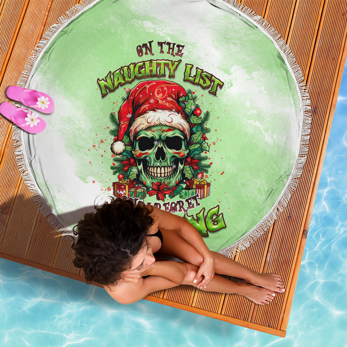 Round green beach blanket with skull Santa graphic and fringed edge