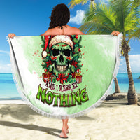 Round green beach blanket with skull Santa graphic, fringed edge held open