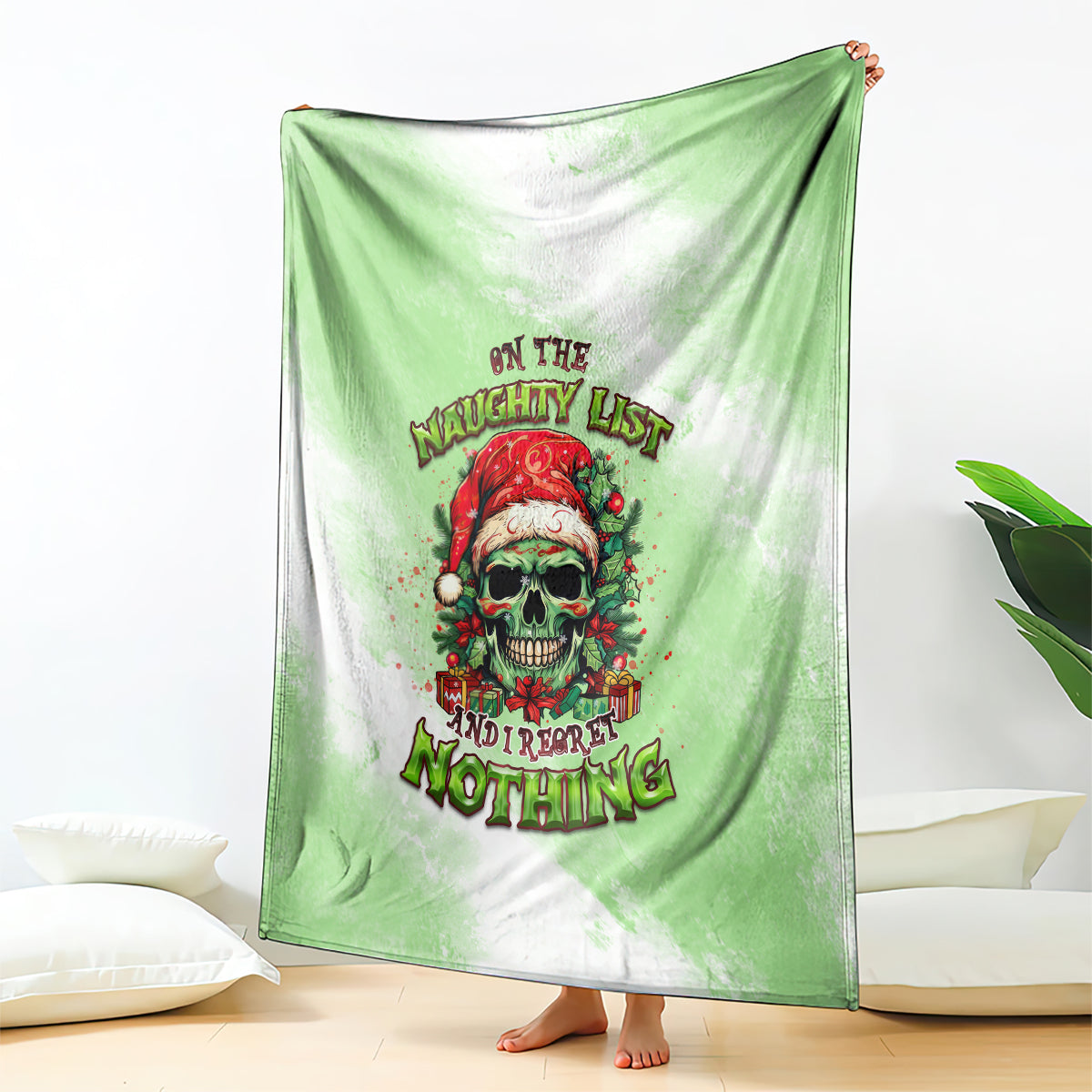 Christmas throw blanket with green base, skull Santa graphic and multicolor holiday wording