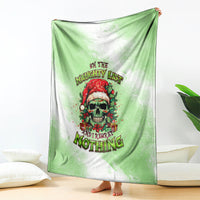 Christmas throw blanket with green base, skull Santa graphic and multicolor holiday wording