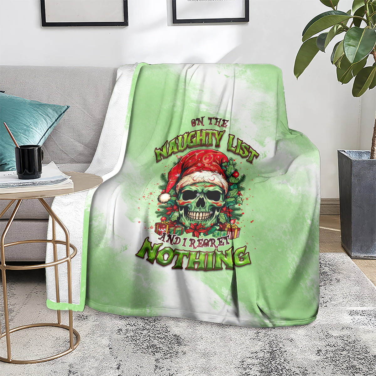 Christmas blanket with green gradient, skull Santa graphic and holiday lettering, on floor