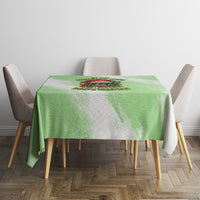 Green Christmas tablecloth with skull wreath print on square table and four chairs