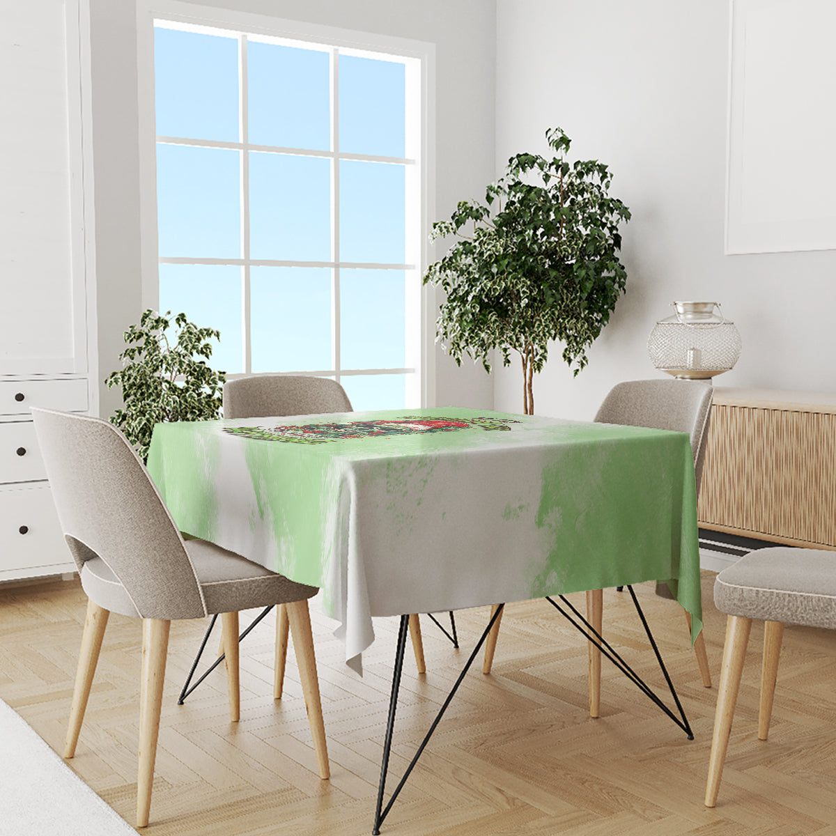 Green Christmas tablecloth draped on round dining table with skull wreath motif