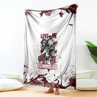 Skull graphic blanket draped on floor: white fabric with dark red splatter and skull portrait text