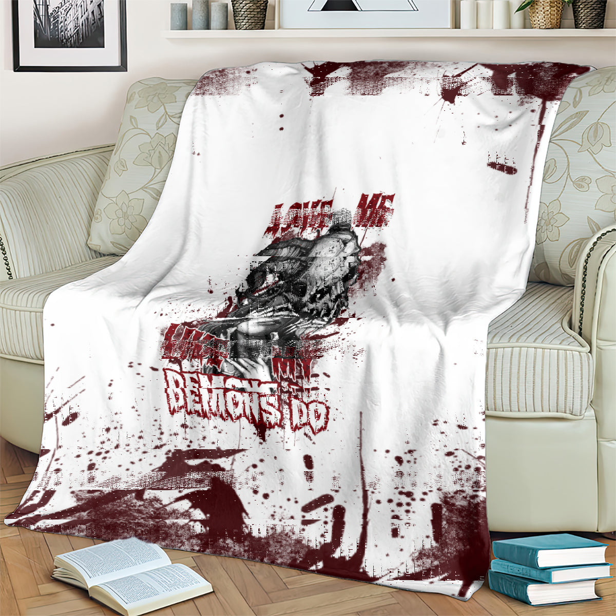 Skull graphic blanket on couch: white with dark red splatter, skull portrait, and “DEMONS DO” text