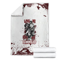 Skull graphic blanket with rolled stacks: white fabric with dark red splatter and “DEMONS DO” text