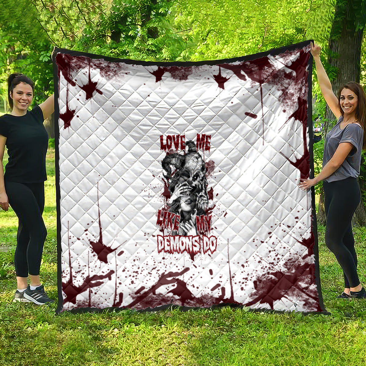 Skull graphic quilt with quilted pattern, white base with dark red splatter and text