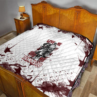 Skull graphic quilt on bed, white quilted fabric with dark red splatter and text