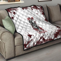 Skull quilt thrown over sofa, white quilted pattern with dark red splashes and print